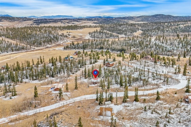 snowy aerial view with a mountain view