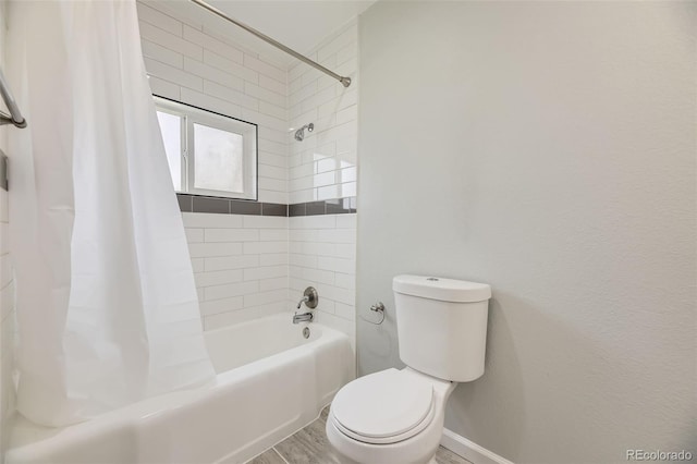 bathroom featuring toilet, shower / bathtub combination with curtain, wood finished floors, and baseboards