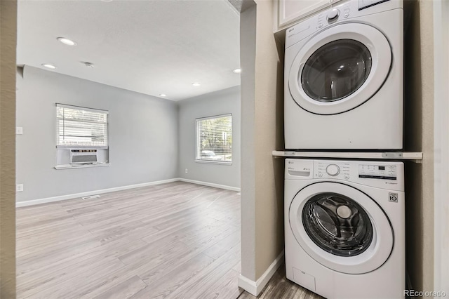 washroom with stacked washer / dryer, light wood-style flooring, baseboards, cooling unit, and recessed lighting