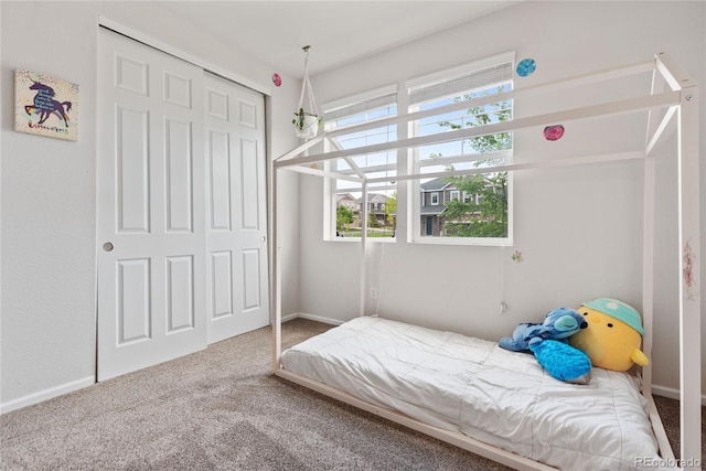 carpeted bedroom with a closet