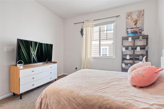 bedroom with baseboards and carpet