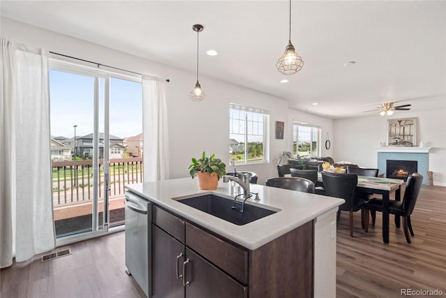 kitchen featuring a sink, open floor plan, light wood-style flooring, dishwasher, and recessed lighting