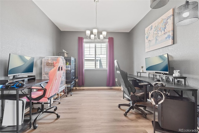 office space with wood finished floors, a chandelier, baseboards, and a textured wall
