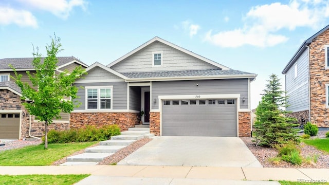 craftsman-style home with stone siding, an attached garage, and concrete driveway