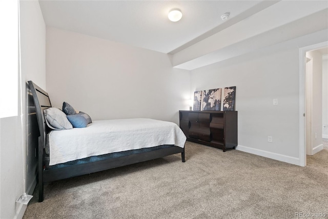 bedroom featuring carpet and baseboards