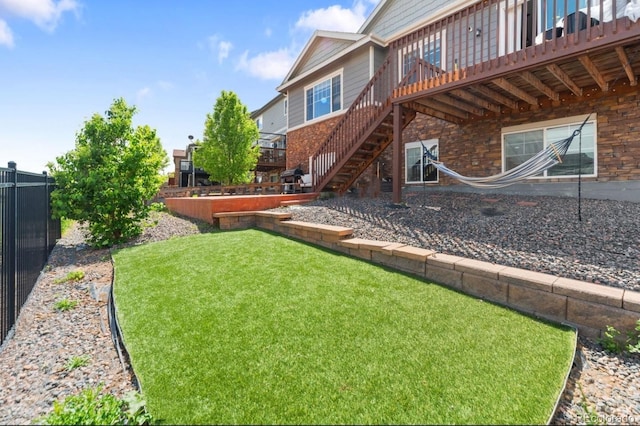 view of yard with a wooden deck and stairway