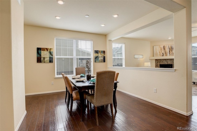 13351 Olive Way, Thornton, CO 80602 - dining area featuring wood-type flooring, baseboards, a fireplace, and recessed lighting