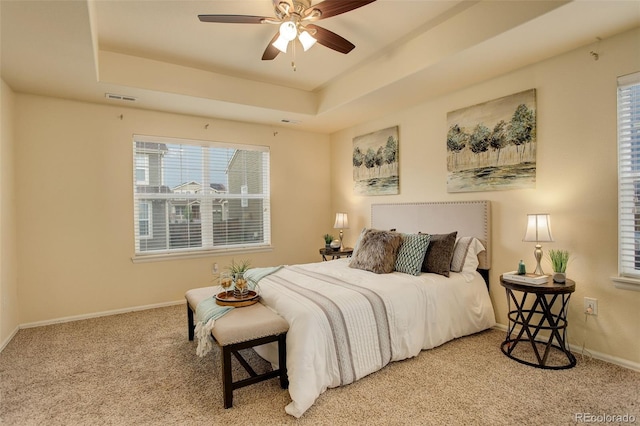 13351 Olive Way, Thornton, CO 80602 - carpeted bedroom featuring a raised ceiling, baseboards, and a ceiling fan