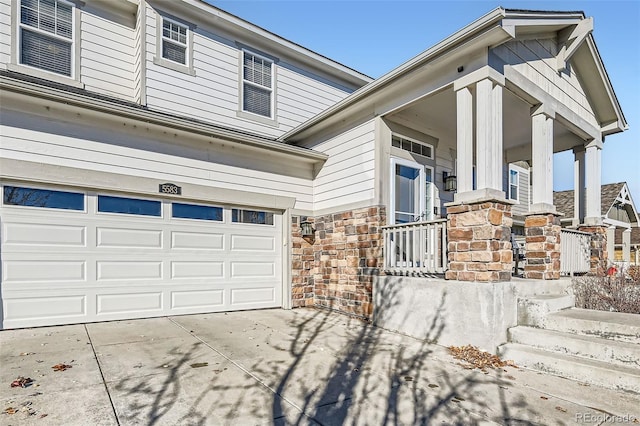 view of front of home featuring a porch and a garage