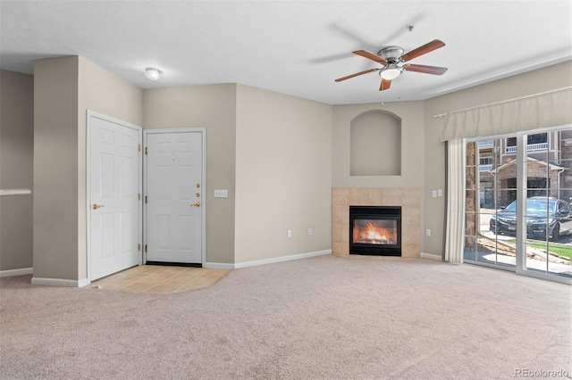 7440 S Blackhawk St Unit 104, Englewood, CO 80112 - unfurnished living room featuring carpet, ceiling fan, and a tile fireplace