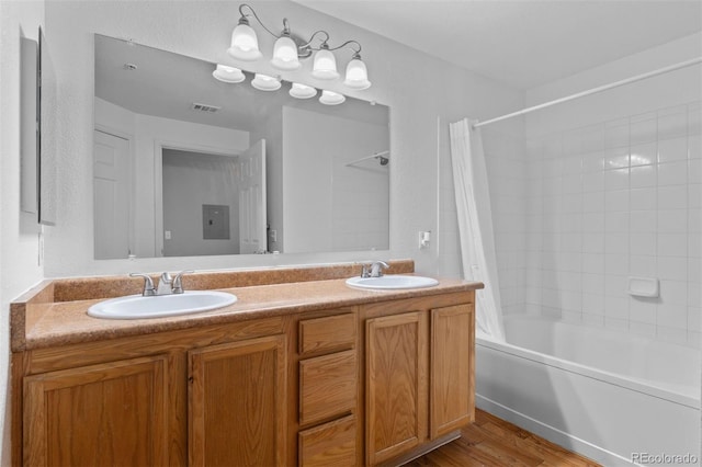 7440 S Blackhawk St Unit 104, Englewood, CO 80112 - bathroom with shower / bath combo, double vanity, and wood finished floors