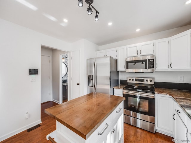 kitchen with white cabinetry, dark hardwood / wood-style floors, and appliances with stainless steel finishes