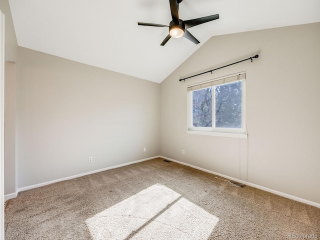 spare room with vaulted ceiling, carpet floors, and ceiling fan