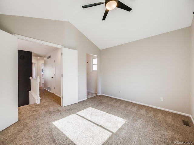 unfurnished bedroom with ceiling fan, vaulted ceiling, and carpet