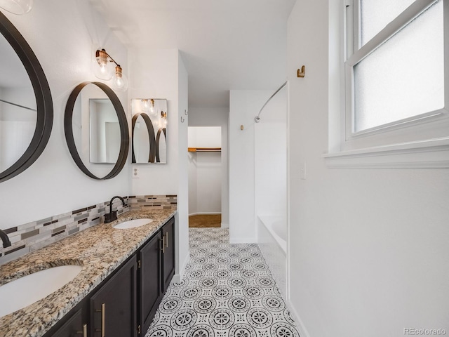 bathroom featuring tasteful backsplash, vanity, and tile patterned floors