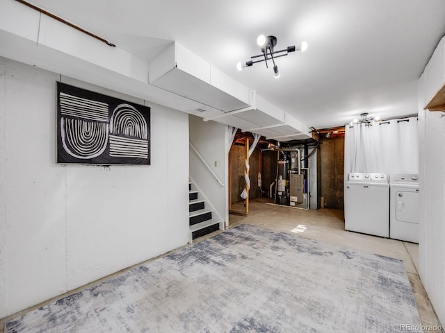 basement featuring heating unit, gas water heater, and washer and clothes dryer