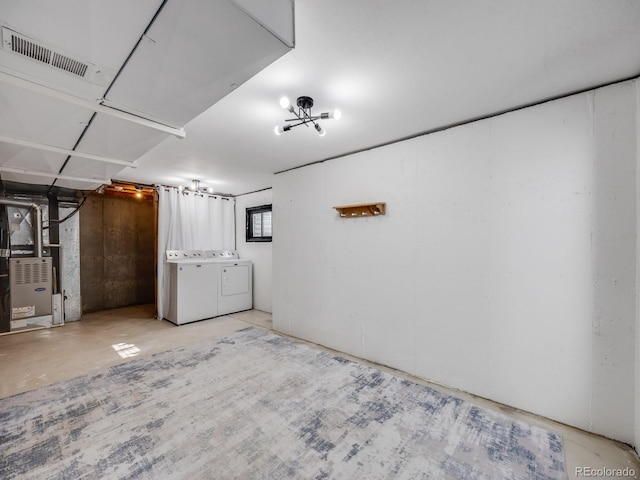 basement with heating unit and washing machine and clothes dryer