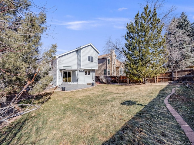 back of house featuring a yard and a patio area