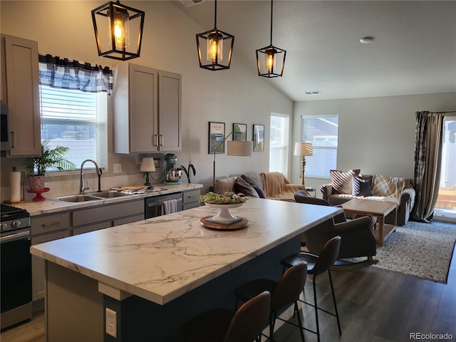 kitchen with a center island, gray cabinetry, and pendant lighting