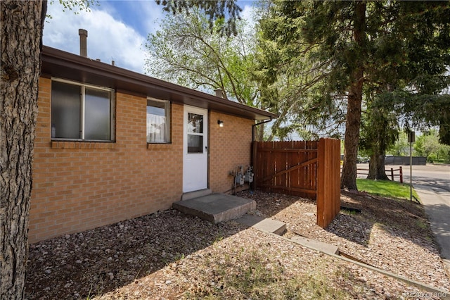 6004 S Prince St, Littleton, CO 80120 - doorway to property featuring brick siding