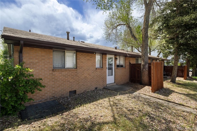 6004 S Prince St, Littleton, CO 80120 - back of property featuring crawl space and brick siding