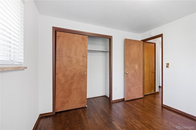 6004 S Prince St, Littleton, CO 80120 - unfurnished bedroom with wood finished floors, baseboards, and a closet