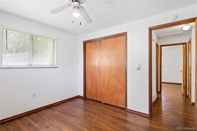 6004 S Prince St, Littleton, CO 80120 - unfurnished bedroom featuring dark wood-style flooring, baseboards, a closet, and attic access