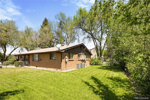 6004 S Prince St, Littleton, CO 80120 - rear view of property with brick siding and central AC