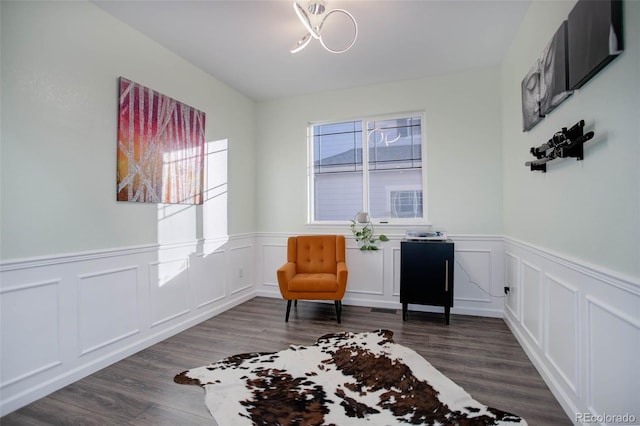 25525 E 1st Ave, Aurora, CO 80018 - sitting room with wainscoting, dark wood-style floors, and a decorative wall