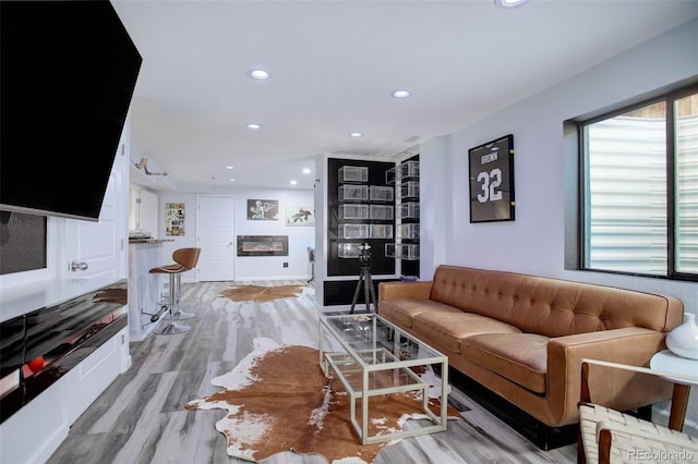 25525 E 1st Ave, Aurora, CO 80018 - living area featuring recessed lighting, light wood-type flooring, and a glass covered fireplace