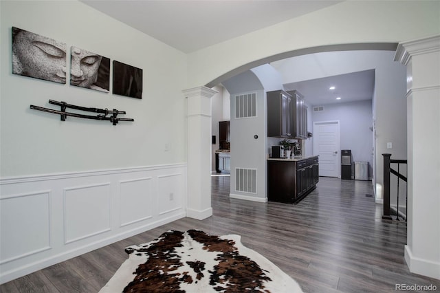 25525 E 1st Ave, Aurora, CO 80018 - hall with dark wood-type flooring, arched walkways, recessed lighting, and wainscoting
