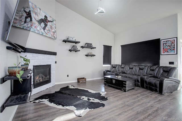 25525 E 1st Ave, Aurora, CO 80018 - living area with high vaulted ceiling, wood finished floors, and a fireplace