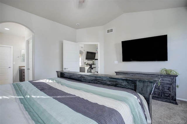 25525 E 1st Ave, Aurora, CO 80018 - bedroom featuring carpet flooring, arched walkways, lofted ceiling, and ensuite bathroom