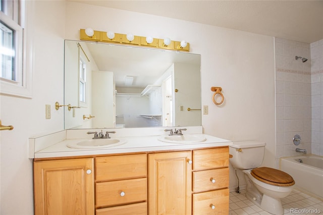 full bathroom with vanity, tile patterned flooring, toilet, and tiled shower / bath combo