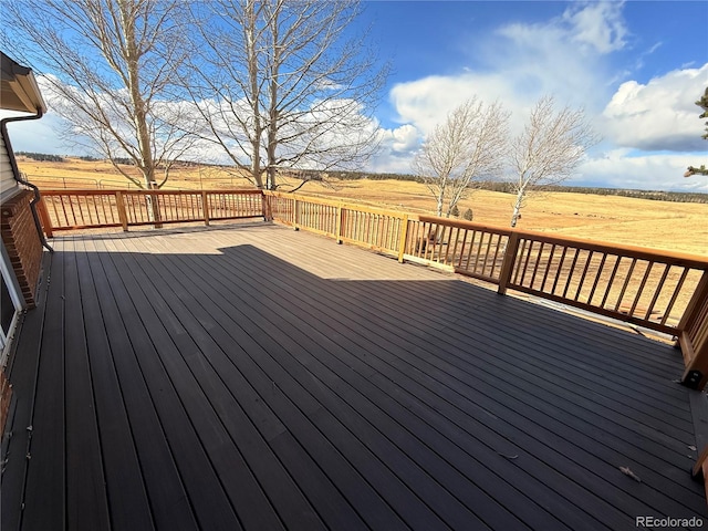 wooden terrace featuring a rural view