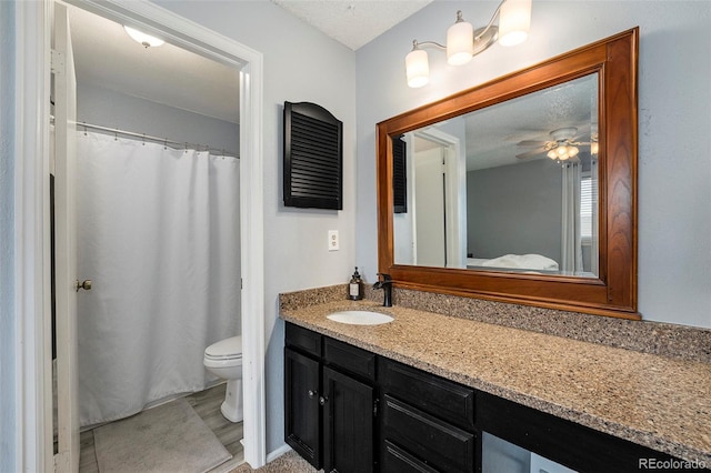 full bathroom featuring vanity, a ceiling fan, and toilet