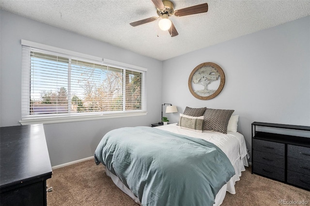bedroom with carpet floors, a textured ceiling, ceiling fan, and baseboards