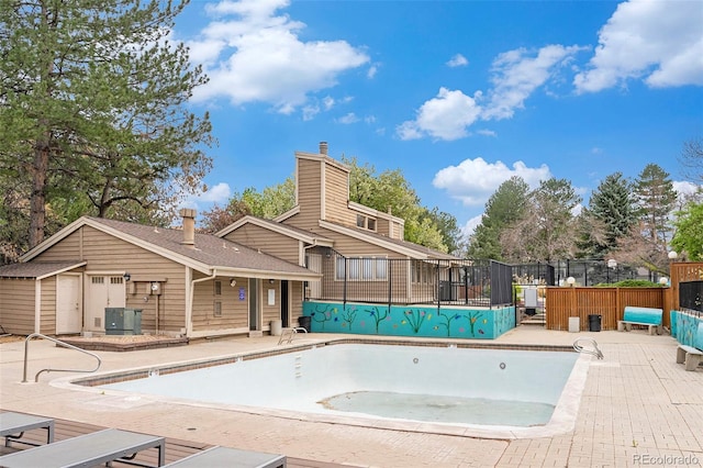community pool featuring fence and a patio