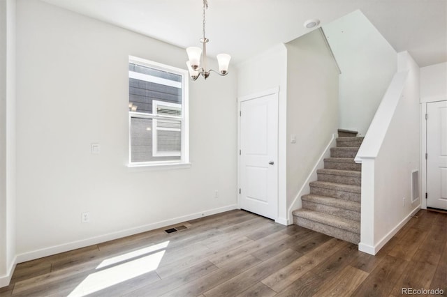 interior space featuring hardwood / wood-style flooring and a notable chandelier