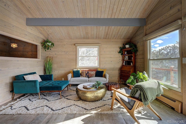 sitting room with wooden ceiling, a baseboard heating unit, light wood-type flooring, and vaulted ceiling with beams