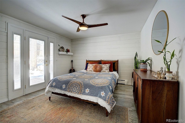 bedroom with multiple windows, access to exterior, ceiling fan, and baseboard heating