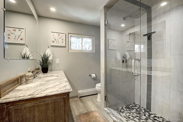 bathroom featuring vanity, a baseboard radiator, toilet, and walk in shower