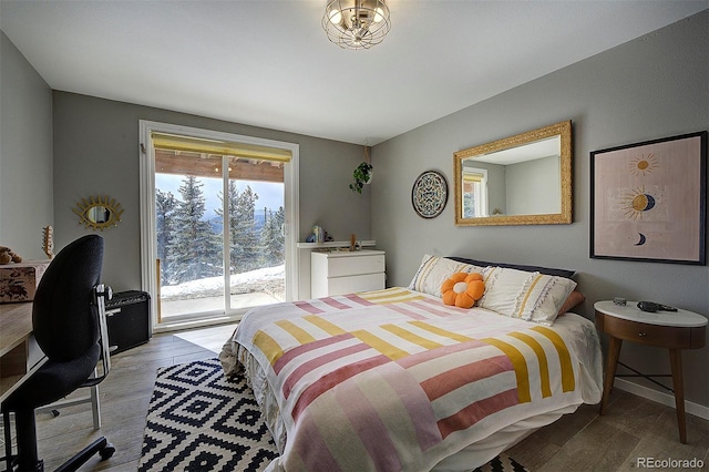 bedroom featuring light hardwood / wood-style flooring and access to outside