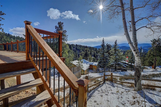 snow covered deck featuring a mountain view