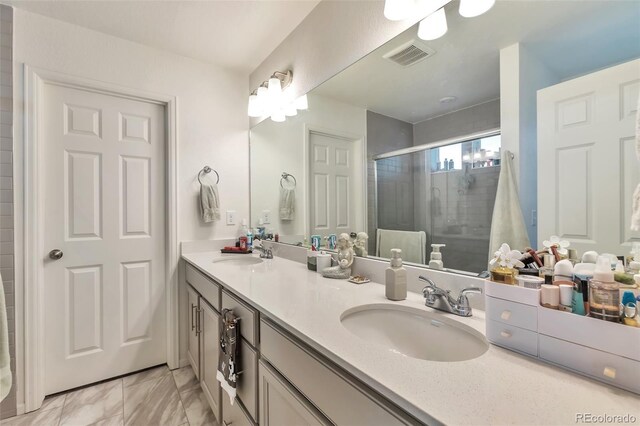 3963 N Quatar Ct, Aurora, CO 80019 - bathroom featuring double vanity, a stall shower, and marble finish flooring