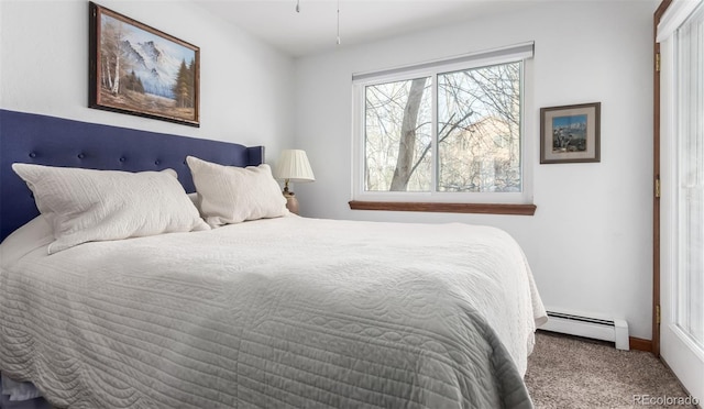 bedroom with carpet and a baseboard heating unit