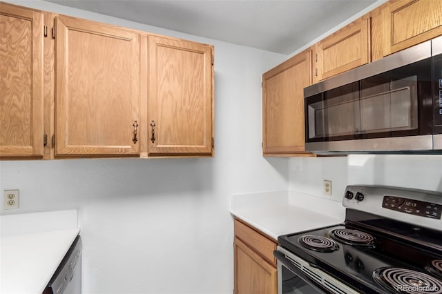 kitchen with appliances with stainless steel finishes, light countertops, and light brown cabinetry