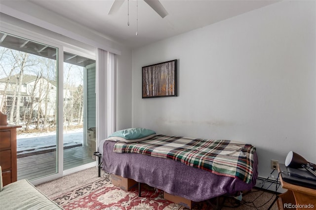 bedroom with ceiling fan, access to outside, and a baseboard radiator