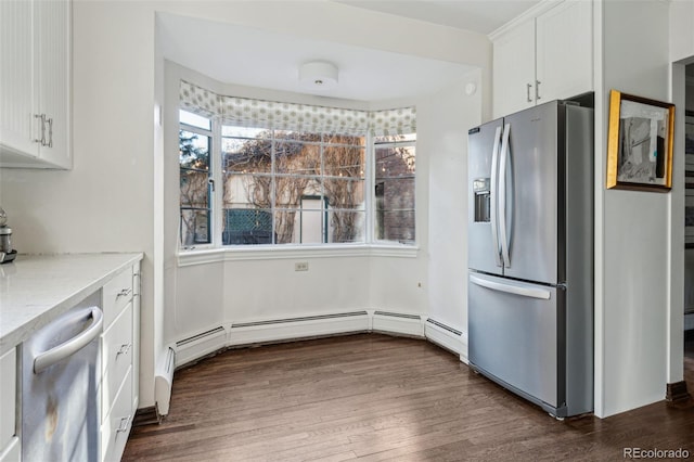 kitchen with light stone counters, stainless steel appliances, white cabinets, and dark hardwood / wood-style floors