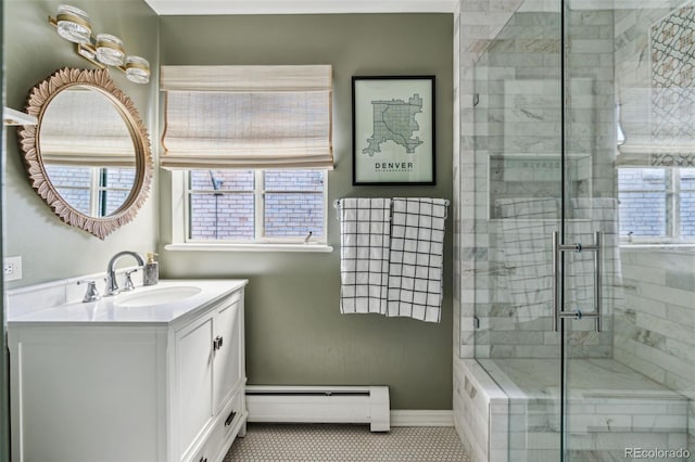 bathroom featuring baseboard heating, tile patterned flooring, an enclosed shower, and vanity